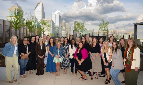 a group of women in front of a city skyline