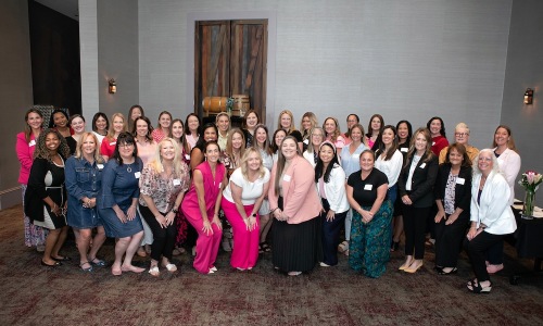 a group of women posing for a photo
