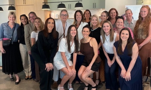 a large group of women posing for a photo